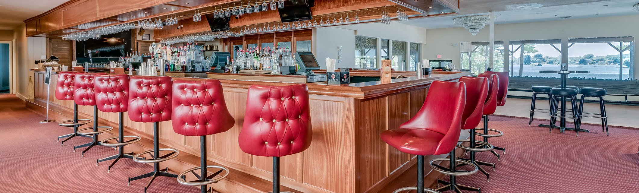 red bar stools around a bar